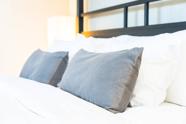 istock Beautiful luxury comfortable pillow on bed with light lamp 1147200994