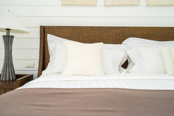 istock Beautiful luxury comfortable pillow on bed with light lamp 1147201056
