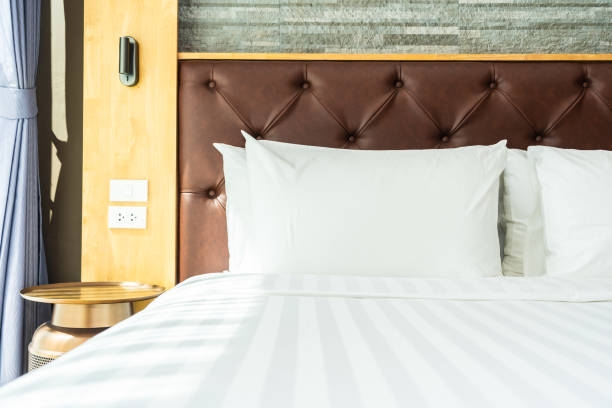 istock Beautiful luxury comfortable pillow on bed with light lamp 1147205877
