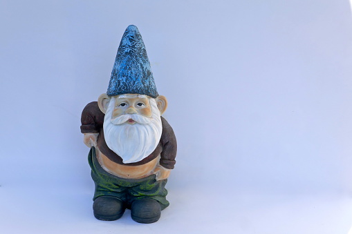 Garden Gnome with slipping pants and bare belly.\nIsolated on white background. (not protected by copyright)