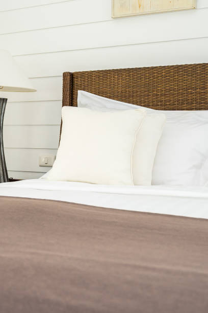 istock Beautiful luxury comfortable pillow on bed with light lamp 1147213503