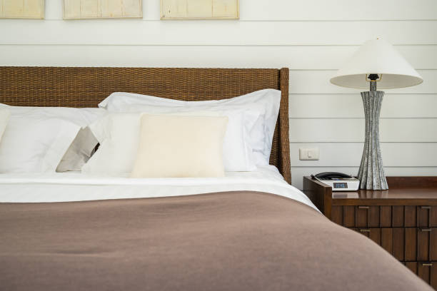istock Beautiful luxury comfortable pillow on bed with light lamp 1147214535