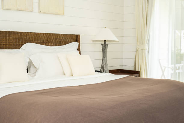 istock Beautiful luxury comfortable pillow on bed with light lamp 1147217148