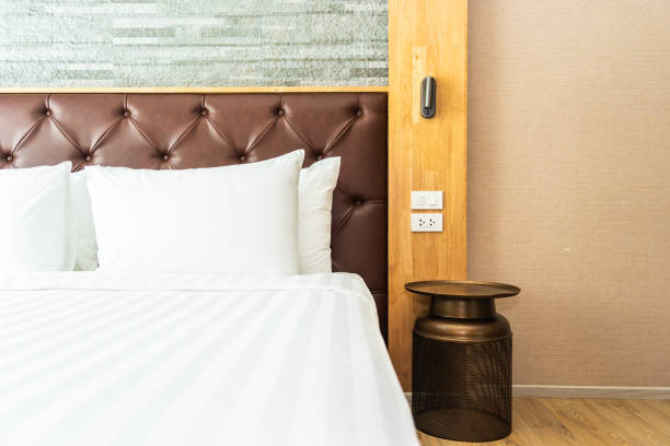 istock Beautiful luxury comfortable pillow on bed with light lamp 1147218187