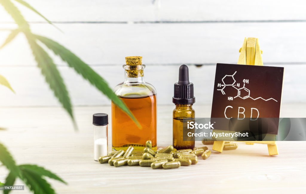Cannabidiol CBD oils, capsules and crystals isolate with small blackboard with CBD word and chemical structure Cannabidiol CBD oils, capsules and crystals isolate with small blackboard with CBD word and chemical structure on wooden backdrop Cannabidiol Stock Photo