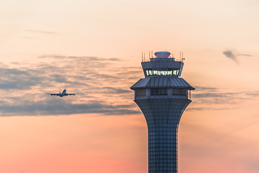 Airport traffic control tower at sunset