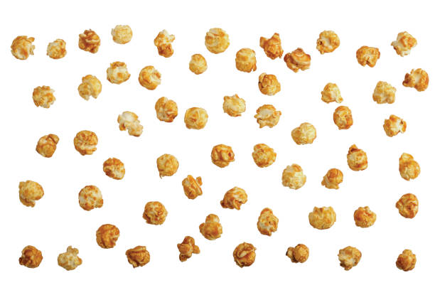 scattered sweet caramel popcorn isolated on white. without shadows, view from above