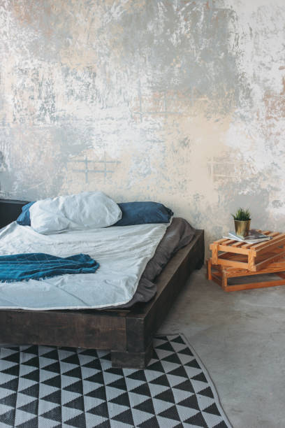 istock Modern eco loft interior in bedroom, concrete floor, bed, minimalism 1147222774