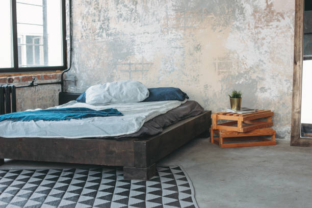 istock Modern eco loft interior in bedroom, concrete floor, bed, minimalism 1147222790