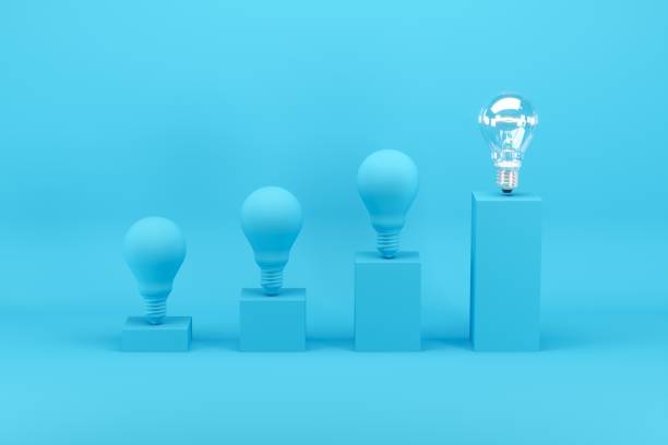 istock Outstanding light bulb among light bulbs painted in blue on bar chart on blue background. Minimal conceptual idea concept. 1147227078