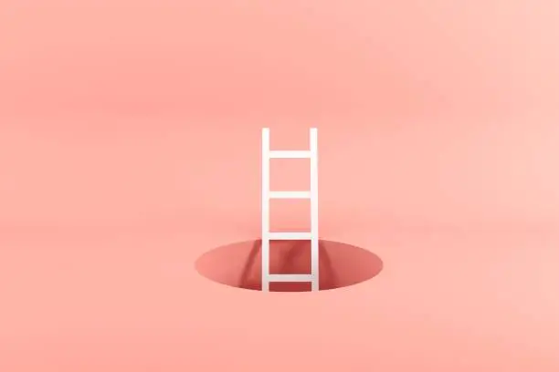 Photo of Outstanding white ladder standing inside hole on pink background. Minimal conceptual idea concept.