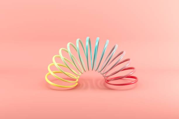 istock Colorful slinky isolated on pink background. Minimal conceptual idea concept. 1147227085