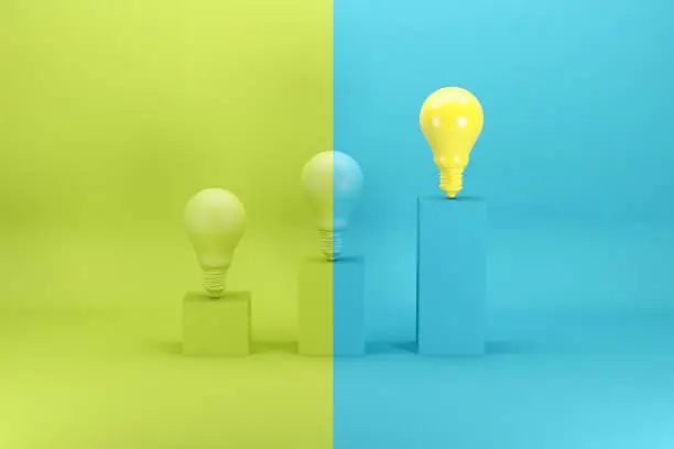 Photo of Outstanding bright yellow light bulb on the highest bar chart on green and blue background. Minimal conceptual idea concept.