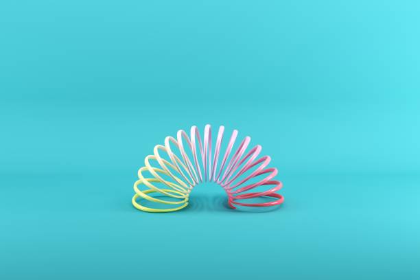 istock Colorful slinky on blue background. Minimal conceptual idea concept. 1147227095