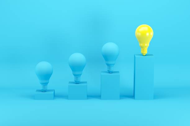 istock Outstanding bright yellow light bulb among blue light bulbs on bar chart on blue background. Minimal conceptual idea concept. 1147227097