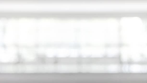 istock Blur business office background interior view empty lobby corridor hallway with glass wall white room and light bokeh 1147228109