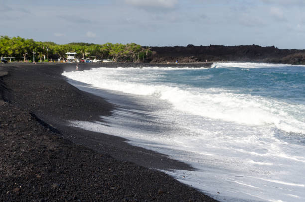 Rough surf  at edge of black sands of Pohoiki  beach, Isaac Hale Beach Park, Big Island, hawaii stock photo