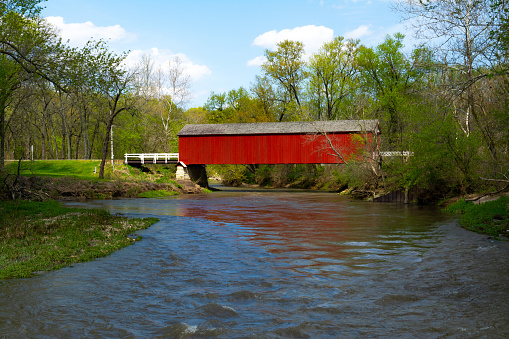 Red covered bridge in the Midwest on a beautiful Spring afternoon.