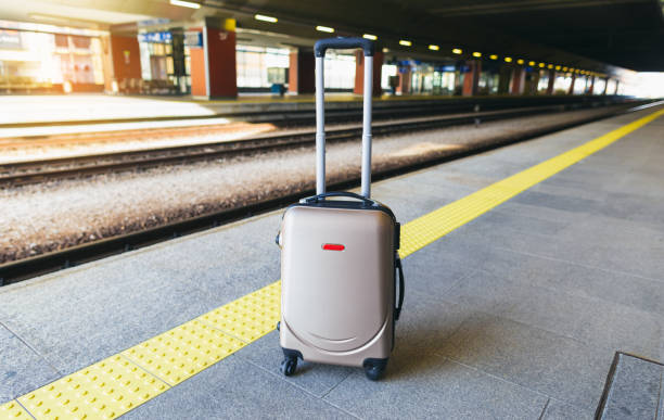 istock Suitcase on platform of the railway station 1147232698