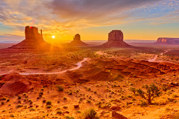 Monument Valley in Arizona The mittens geologic feature in Monument Valley tribal park in Arizona at sunrise butte rocky outcrop photos stock pictures, royalty-free photos & images
