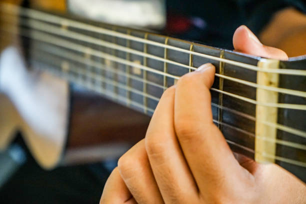istock close up hand playing guitar 1147233419