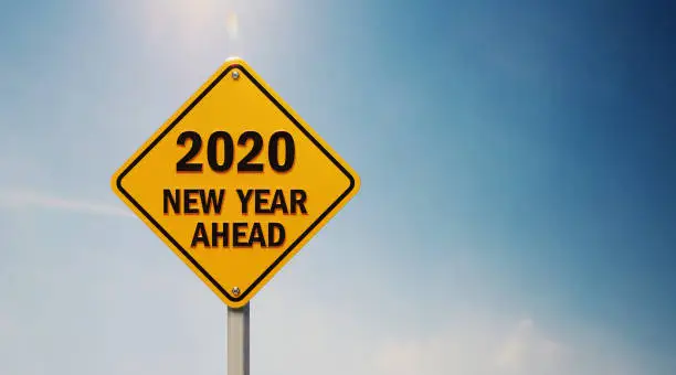 Photo of Yellow Off Road Traffic Sign With 2020 New Year Ahead Text on Blue Sky