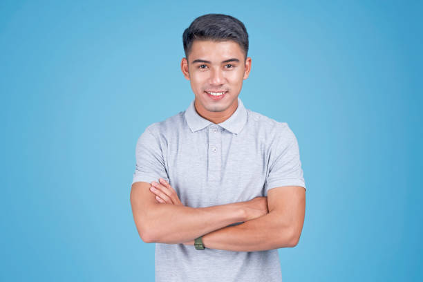 istock Asian young handsome confident student on light blue background 1147236854