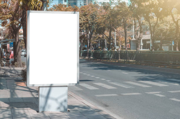 istock big blank billboard white LED screen vertical outstanding in the city on pathway side the road traffic for display advertisement text template promotion new brand at outdoor with green tree 1147237830