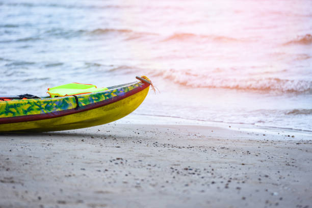 Colorful plastic boat on sandy beach sea background