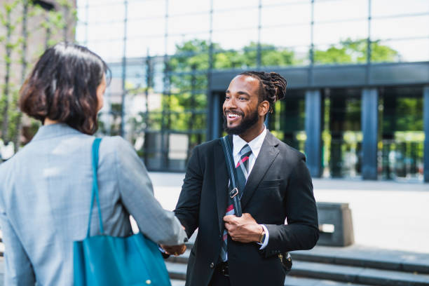 istock Two business people shaking hands in a business district 1147238731