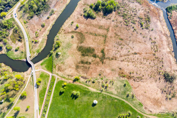 istock spring landscape with river, fields and bicycle lane among them. aerial view 1147238896