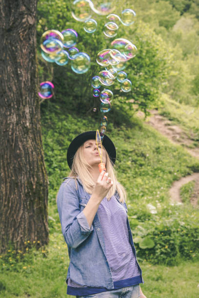 Beautiful woman blowing bubbles toned with a retro vintage