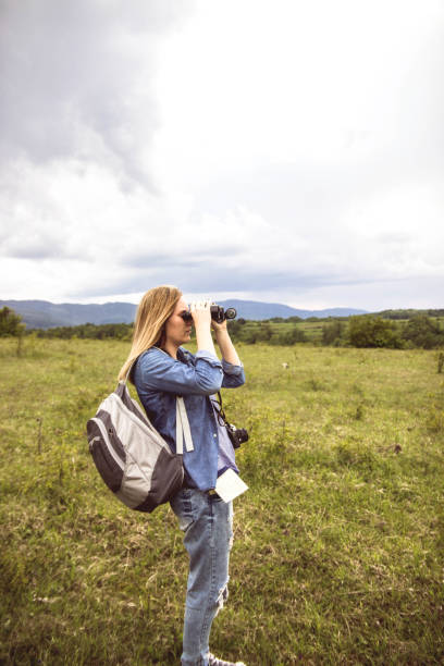 istock Woman looking though binoculars at mountain 1147239752