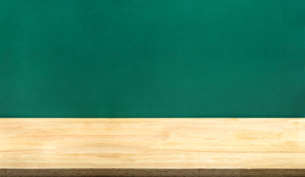 istock Empty wood table and green blackboard at background.education school concept product display template.Business presentation.. 1147239890