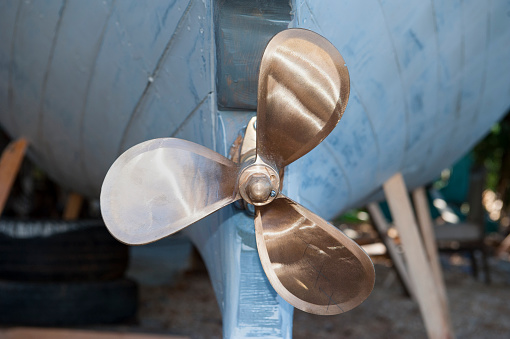 Twin outboard motor boat propellers in the water under the summer sun. Flat Lay. Close-up with copy space.