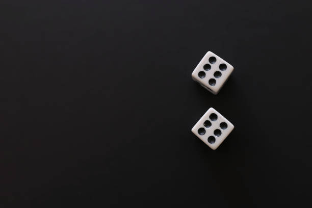 istock Rolling Dices over black background. Casino gambling concept 1147243028