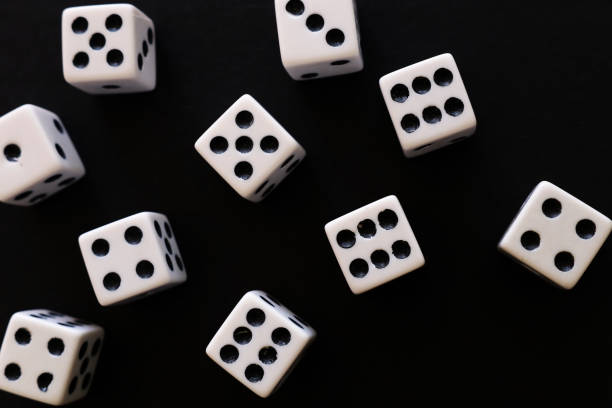 istock Rolling Dices over black background. Casino gambling concept 1147243057