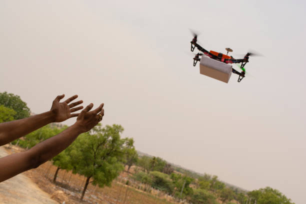 istock Assembled Drone quadcopter delivering a package and hands receiving the parcel 1147244430