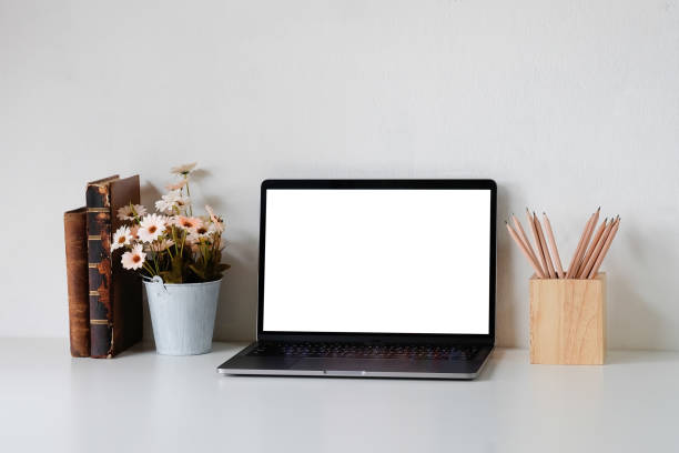 istock Workspace office desk with mockup laptop and office supplies on table. 1147245529