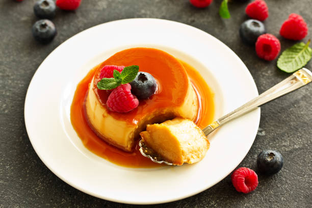 istock delicious dessert creme brulee with berries. 1147245545