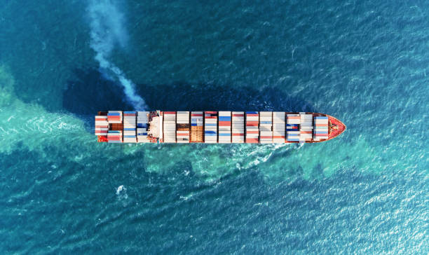 Aerial top view container ship full load container on the sea for logistics, import export, shipping or transportation.