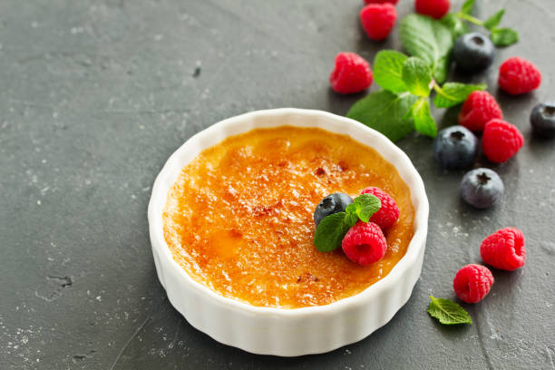 istock Creme brulee. dessert with caramel crust and berries. 1147247873