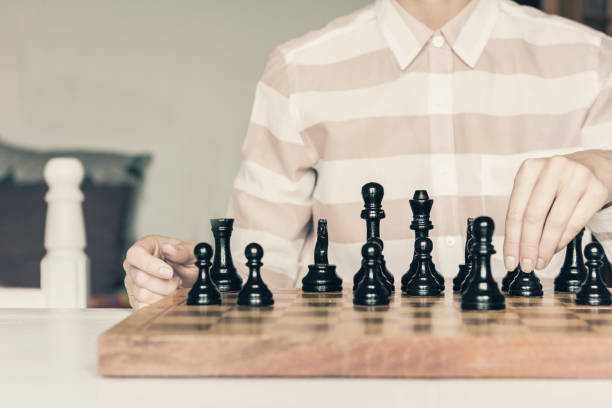 istock Wooden chess pieces on a chessboard, chess game woman player makes a move 1147247917