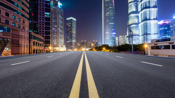 istock Shanghai modern commercial office buildings and empty highway at night 1147249546