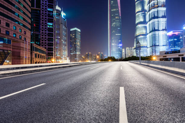 istock Shanghai modern commercial office buildings and empty highway at night 1147250118