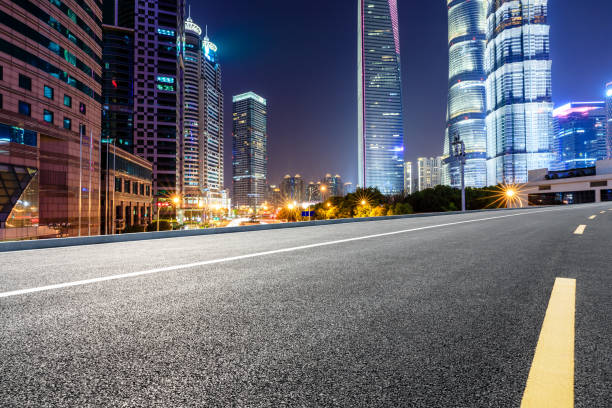 istock Shanghai modern commercial office buildings and empty highway at night 1147250156