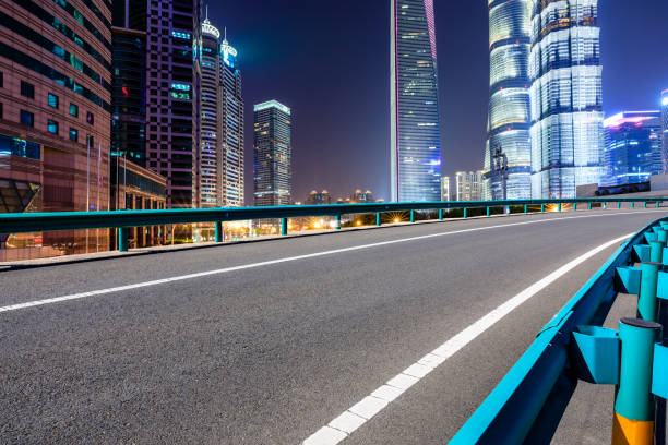 istock Shanghai modern commercial office buildings and empty highway at night 1147250209