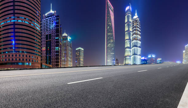 istock Shanghai modern commercial office buildings and empty highway at night 1147250214