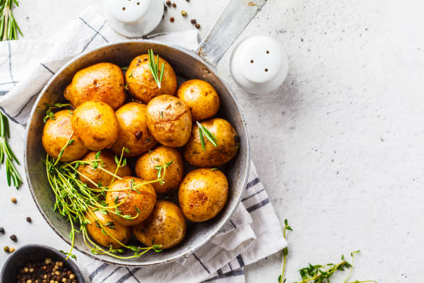 istock Baked potatoes in a cast iron skillet, top view. 1147252411