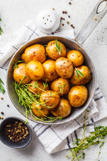 istock Baked potatoes in a cast iron skillet, top view. 1147252433